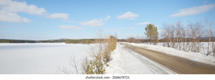 Empty Old Asphalt Road (highway) Through The Pine Forest. Snow-covered Mountains. Winter Landscape. Kola Peninsula, Polar Circle, Russia. Expedition, Work, Route, Logistics, Remote Places, Off-road