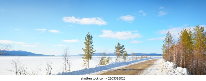 Empty Old Asphalt Road (highway) Through The Pine Forest. Snow-covered Mountains. Winter Landscape. Kola Peninsula, Polar Circle, Russia. Expedition, Work, Route, Logistics, Remote Places, Off-road