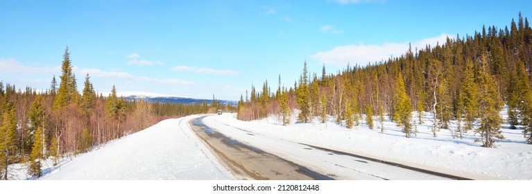 Empty Old Asphalt Road (highway) Through The Pine Forest. Snow-covered Mountains. Winter Landscape. Kola Peninsula, Polar Circle, Russia. Expedition, Work, Route, Logistics, Remote Places, Off-road