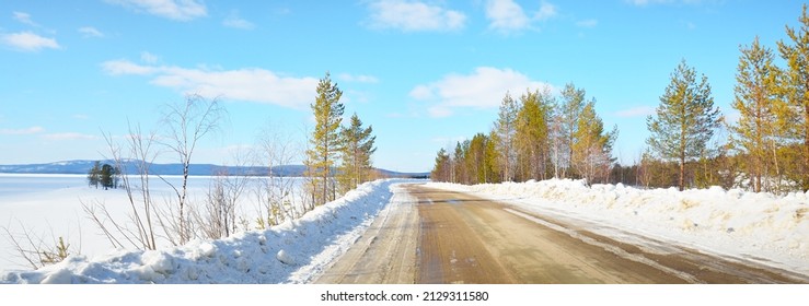 Empty Old Asphalt Road (highway) Through The Pine Forest. Snow-covered Mountains. Winter Landscape. Kola Peninsula, Polar Circle, Russia. Expedition, Work, Route, Logistics, Remote Places, Off-road