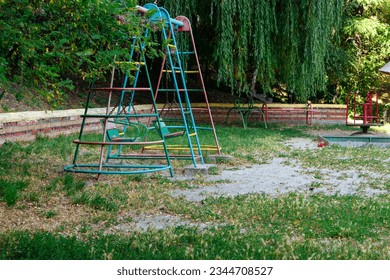 Empty old swings in an abandoned playground - Powered by Shutterstock