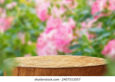 Empty old tree stump table top with blur rose garden background for product display - Powered by Shutterstock