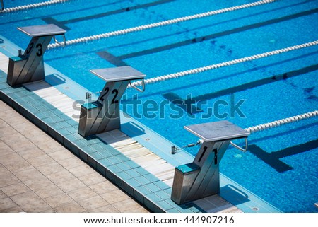 Empty olympic swimming pool with clear blue water