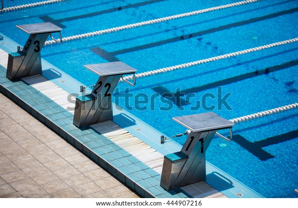 Empty olympic\
swimming pool with clear blue\
water
