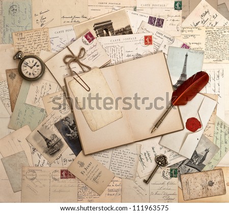 empty open book, old accessories and post cards. sentimental vintage background