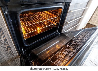 Empty Open Electric Oven With Hot Air Ventilation. New Oven. Door Is Open And Light Is On