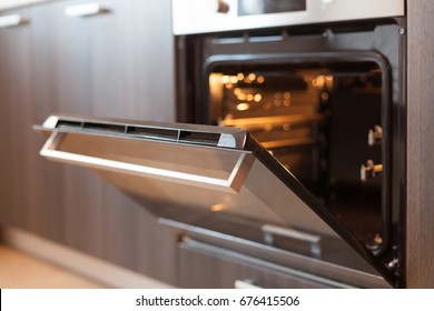 Empty open electric oven with hot air ventilation. New oven. Door is open and light is on - Shutterstock ID 676415506