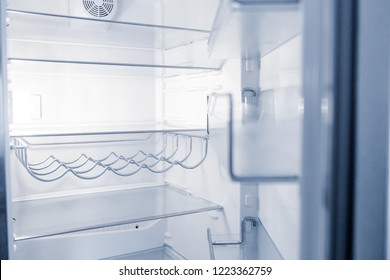 Empty Open Fridge With Shelves In The Kitchen At Night