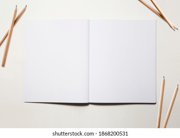 Empty open notebook with pen cil on background