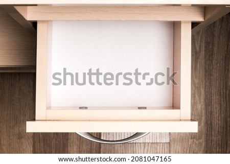 Empty open pull-out furniture drawer, top view
