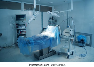 Empty Operating Room With Patient Lying Under Cover