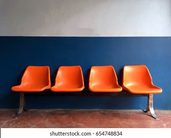 Empty Orange Chair, Blue Wall And Red Floor In Office