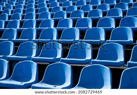 empty outdoor arena. concept of fans. chairs for audience. cultural environment concept. color and symmetry. empty seats. modern stadium. blue tribunes. seats of tribune on sport stadium