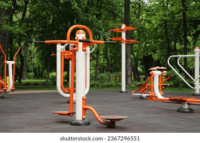 Empty outdoor gym with air walker, ovate stepper, twister and surfer - Powered by Shutterstock