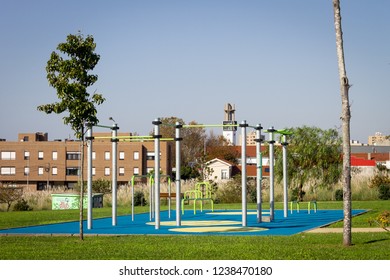 Empty Outdoor Gym Workout Space In A Garden. Lifting Bars. Clear Day.