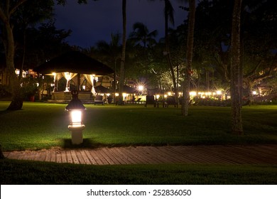 Empty Outdoor Houses Illuminated By Warm Light. Night Time. 