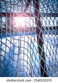 Empty Outdoor Ice Rink With Hockey Net In Winter.