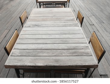 Empty Outdoor Old Vintage Wood Table And Chair In Coffee Shop Restaurant 