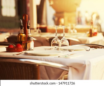 Empty outdoor restaurant table at sunset