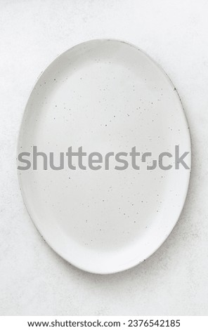 An empty oval dish on a light background. Top view. Copy space.