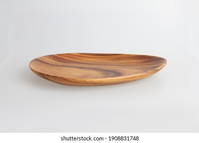 Empty oval wooden tray on a white back ground.