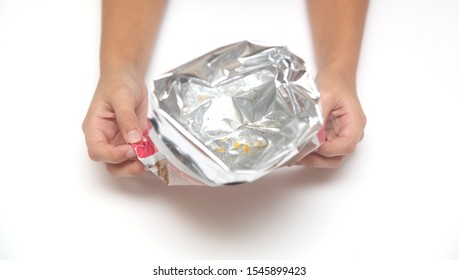 empty package from under the chips in hands