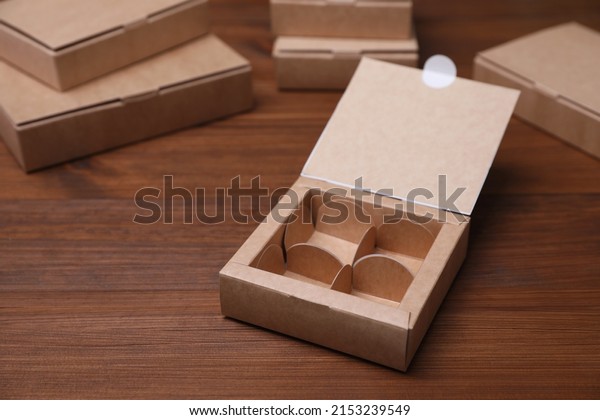 Empty packaging box with dividers on wooden table.\
Production line