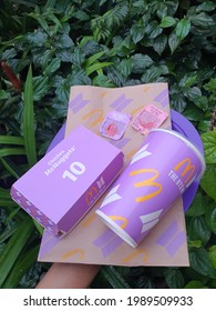 Empty packaging of McDonald's BTS meal. Famous boy band group from South Korea. Purple theme. Die hard fans collection. Green garden background. Malaysia. June 2021