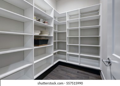 Empty Pantry Interior With White Shelves And Dark Wood Floor. Northwest, USA
