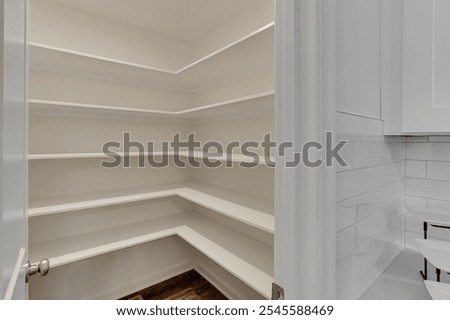Empty Pantry With White Shelves And Ample Storage Room.