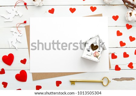 Empty papaer cards decorated with heart, miniature house with heart, golden key on wooden background, Valentine's Day Mock up template flat lay