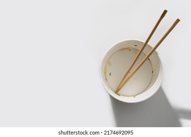 Empty Paper Bowl With Chinese Stick On White Background.Top View, Flay Lay.