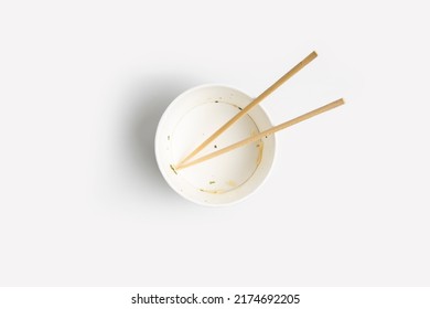 Empty Paper Bowl With Chinese Stick On White Background.Top View, Flay Lay.