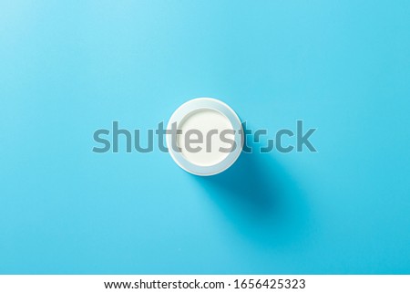 Empty paper cup for drinks on a blue background. Banner. Flat lay, top view