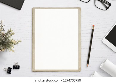 Empty Paper Mockup, On Old Folder, White Wooden Work Desk. Top View, Flat Lay.