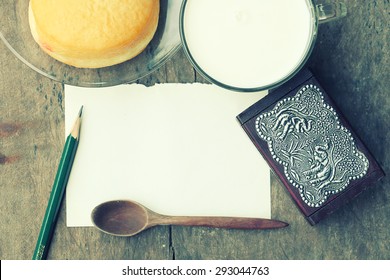  empty paper note  with a cup of fresh milk on old wooden table.Vintage Style
