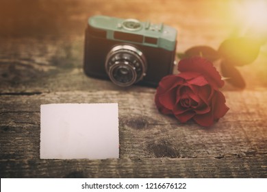 Empty paper for text with retro camera and rose in back, romantic memory 