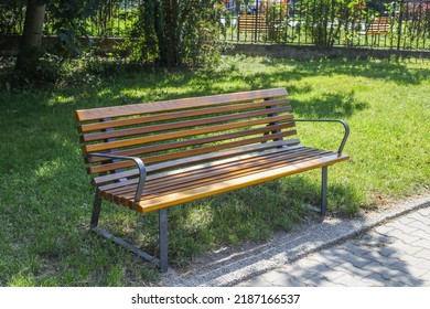 Empty Park Bench In City