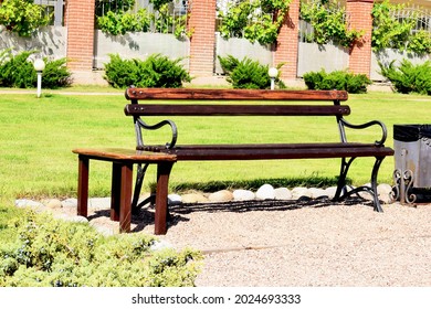 Empty Park Bench In Spring Morning