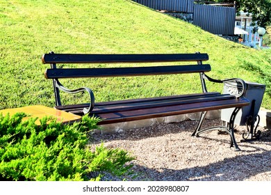 Empty Park Bench In Spring Morning