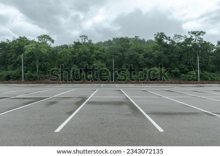 Empty parking lot against mountains and beautiful forests.