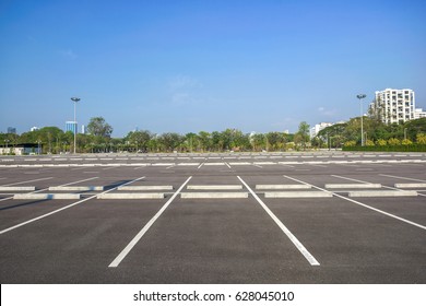 Empty Parking Lot At City Center With Blue Sky