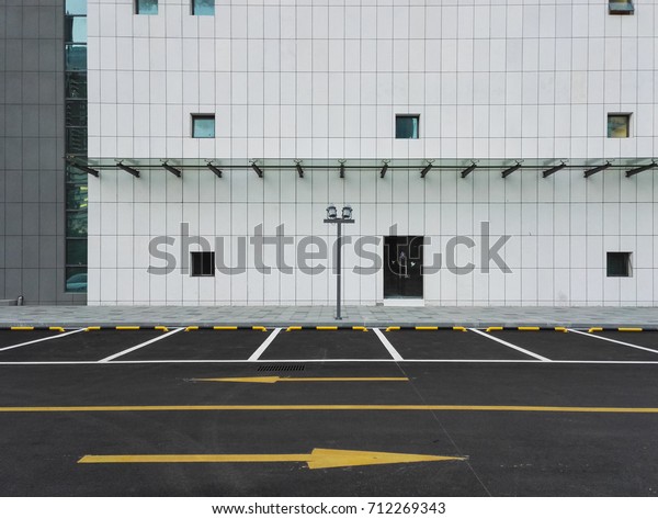 Empty\
parking lot at city center with building\
background