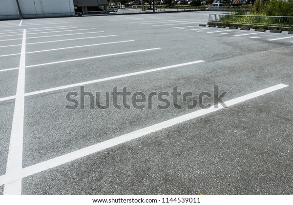 Empty parking lot at city\
center, Vacant Parking Lot, Parking lane painting on floor, copy\
space