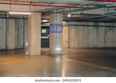 Empty parking lot with dim light. Underground parking garage - Powered by Shutterstock