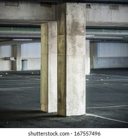 Empty parking garage interior with two concrete columns. 