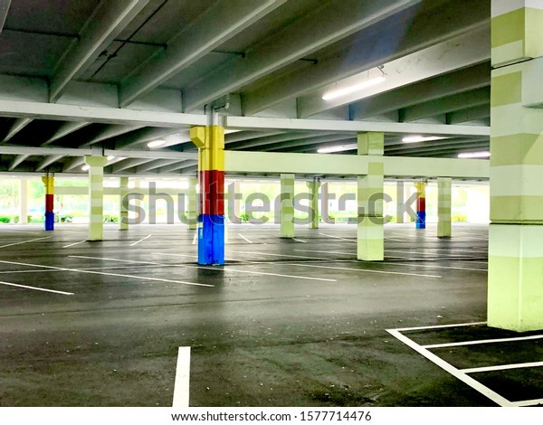 Empty\
parking garage outside of a once busy shopping mall. Retail\
apocalypse on display in a haunting parking\
garage