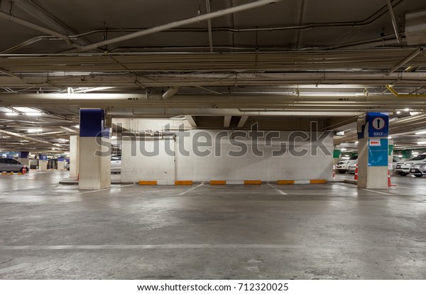 Empty parking garage underground interior in\
apartment or in\
supermarket