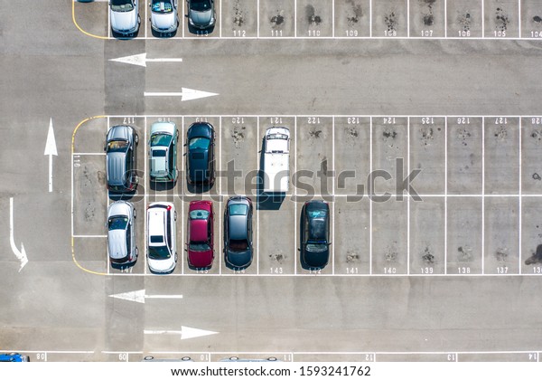 Empty parking lots, aerial\
view. A lot of cars in the parking lot. Colorful moody drone\
shoot.