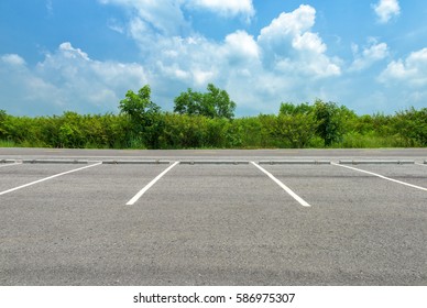 Empty parking lot on blue sky background - Shutterstock ID 586975307